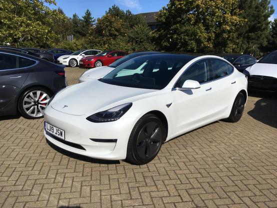 White pre-facelift Tesla Model 3, front quarter view