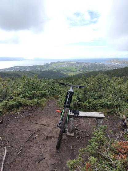 view of Bodø from a nearby hill with an off-road bike up front