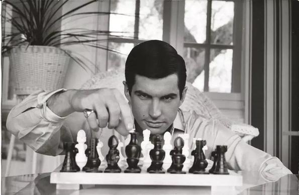 In a photo by Curt Gunther, George Hamilton stares intently at a chess set.