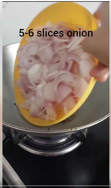 Screenshot of a small plateful of sliced onions being emptied into a kadai - with text at the top of the screen that reads: 