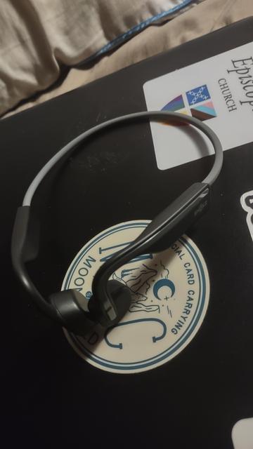 Shokz OpenMove headphones sitting on my laptop. 