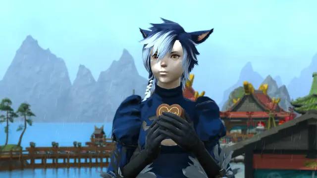 A blue-haired miqo'te holding a large heart-shaped chocolate. She is in the middle of chewing. The screenshot is from before the Dawntrail graphics update.