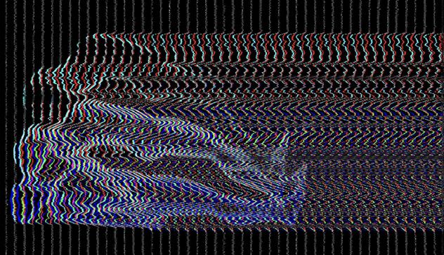 Abstract digital glitch art. The image is composed of wavy, distorted horizontal lines in various colors - predominantly blue, red, and white - against a black background. The pattern suggests a warped electronic signal or corrupted digital data, creating a sense of movement and instability.