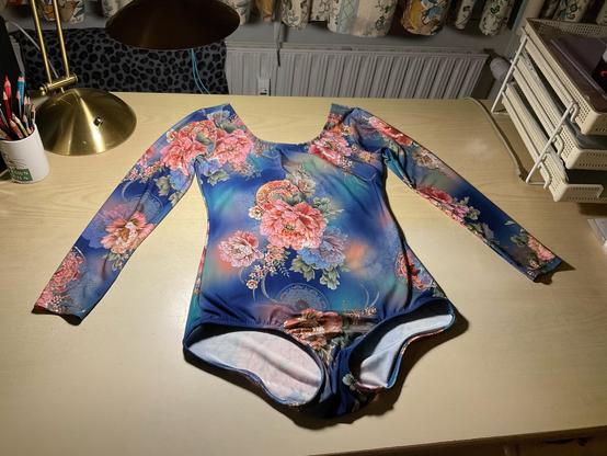 Homemade leotard in azure blue fabric with oriental peonies in pink.