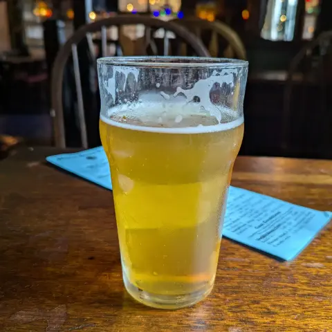 Pint of Fresh Hop Phaedrus IPA from Culmination Brewing of Portland, Oregon. It's sitting on a well used table in the Horse Brass Pub, an iconic English style pub.