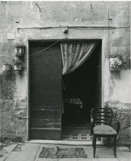 Black and white photo of a doorway on a building. 