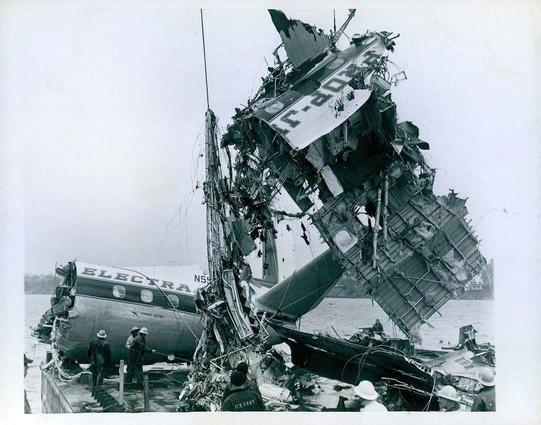 the tail sits on a barge, while more the fuselage is dragged out of the water. 