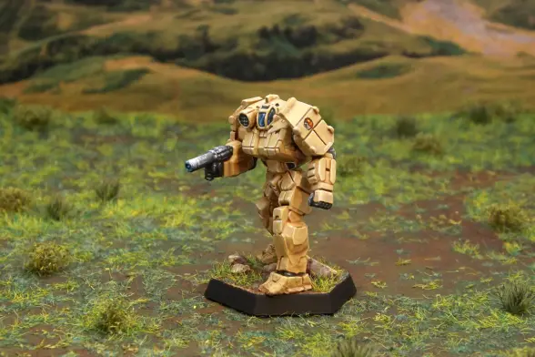 A painted miniature of a Griffin 'Mech.  It is tan and the cockpit glass is blue.  The emblem of the RDF 3 is on the left shoulder.  The miniature is photographed on grassy terrain.