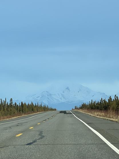 Denali in the distance, somewhat hazy. The highway is in the foreground. 