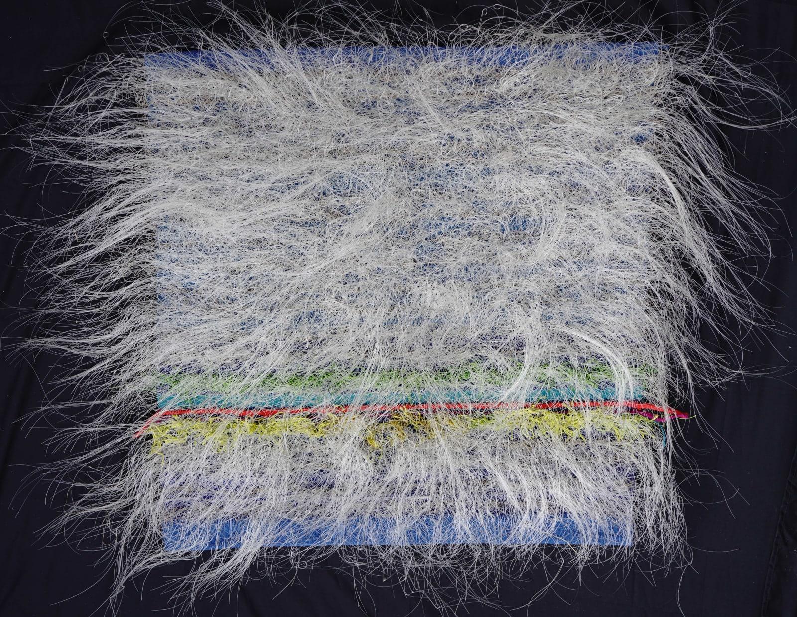 Hanging wall sculpture of curvy white fibers cascading outward from a square canvas with colorful stripes underneath