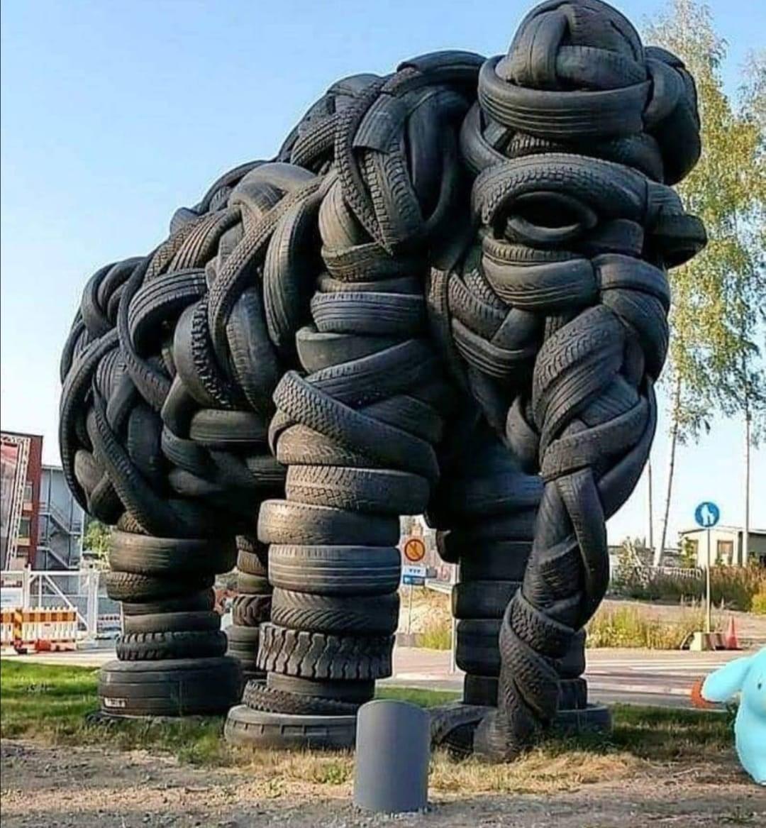 "Looking Tyred&quot; – A monumental elephant sculpture crafted from intricately woven recycled tires by Estonian artist Villu Jaanisoo. This striking public artwork, located in Jyväskylä, Finland, transforms discarded rubber into a powerful and <br />textured representation of the majestic animal. The thick, overlapping tires create a sense of movement and depth, with the elephant’s trunk, ears, and legs sculpted in incredible detail. Positioned in an outdoor urban setting, the sculpture is both a <br />statement on sustainability and a testament to creative reuse in contemporary art.