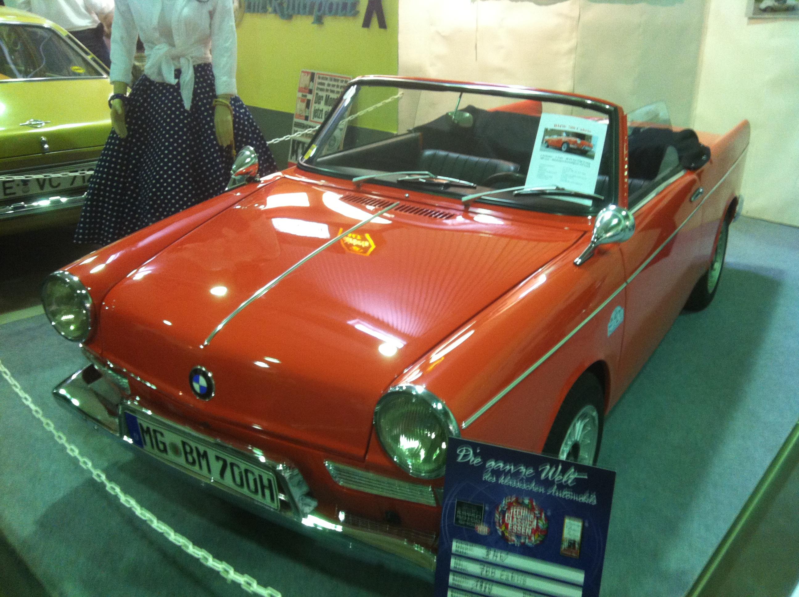 Orange open-topped BMW 700, front quarter view