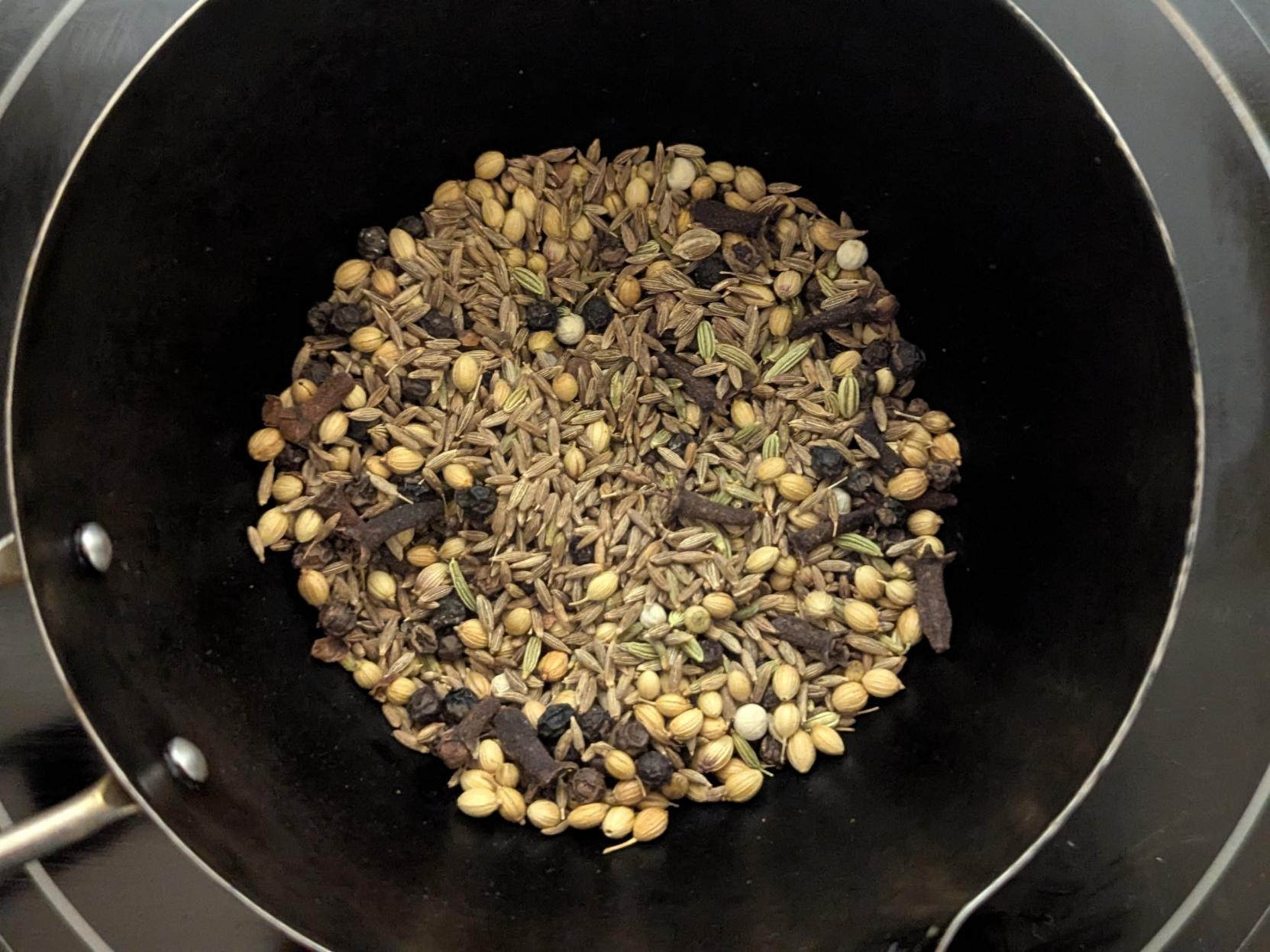 Small metal pot on a hot plate. All the ingredients in the previous pic and coriander seeds too