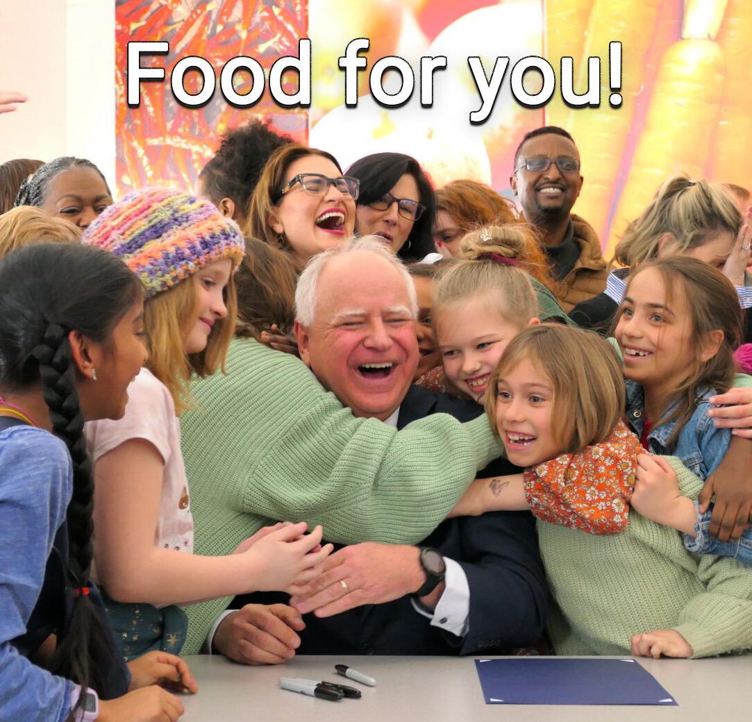 Gov Tim Walz surrounded by smiling kids hugging him after signing the bill to feed school kids in #Minnesota