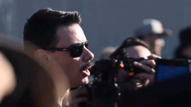 Photographed by Khurram Janjua, M. D., a person out side the Broadview detention center, facing armed, violent crowd control troops, makes an impassioned request for the rule of law over the rule of violence, and implores the troops to return to the side not bringing weapons but bringing faith, asks them to not side with n*zis and instead rejoin their community on the side of righteousness and Justice.