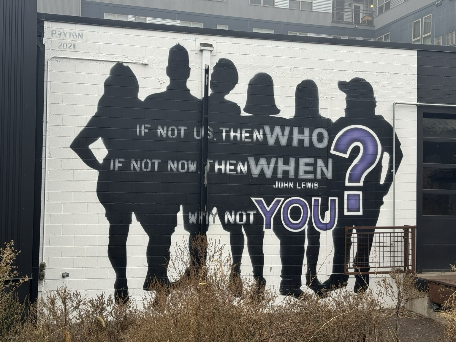 Street art mural showing the silhouettes of six people with the text: “If not us, then who? If not now, then when? Why not you? — John Lewis”