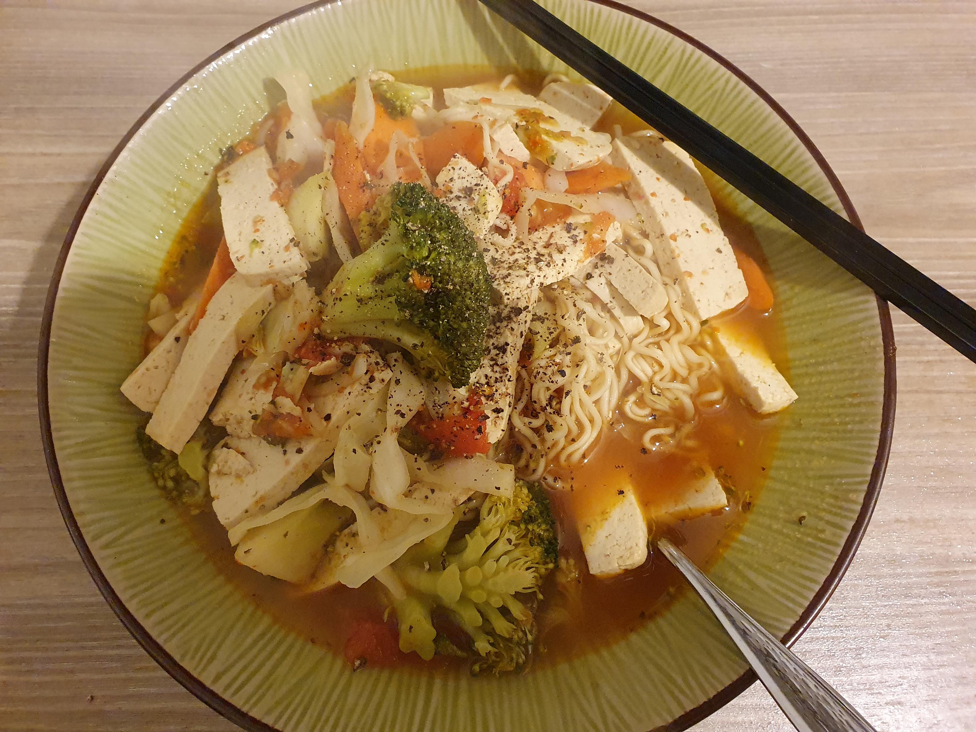 Schon oben beschriebenes Essen im hellgrรผnen Schรผssel mit einem eingesteckten Lรถffel und ein paar schwarzen Stรคbchen