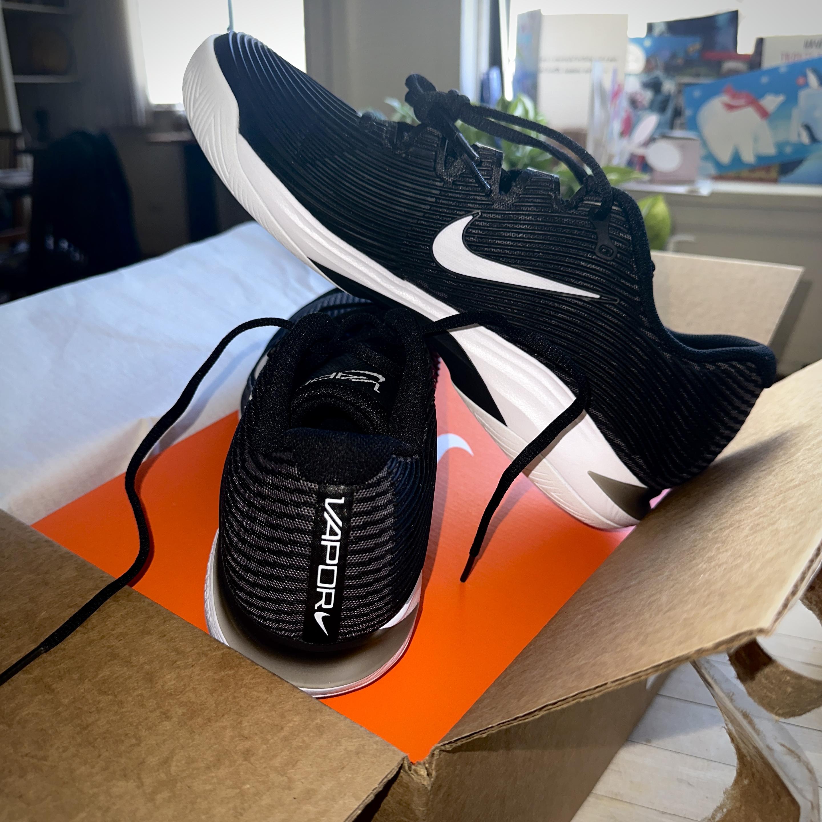 New just out of the box Nike Vapor 12 tennis shoes/trainers in black with white soles.