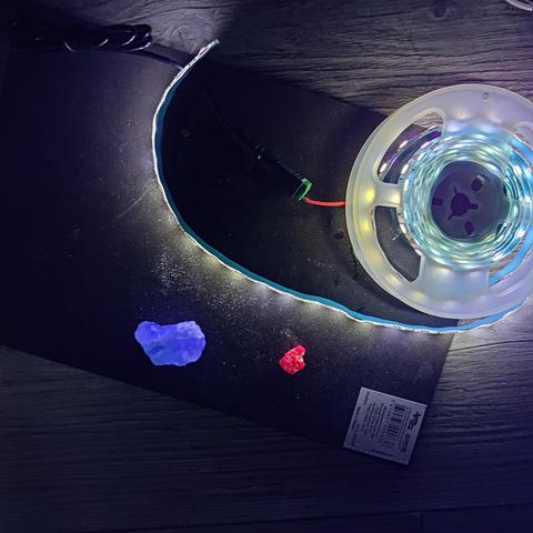 Photo of a couple UV-reactive minerals with UV light shining on them