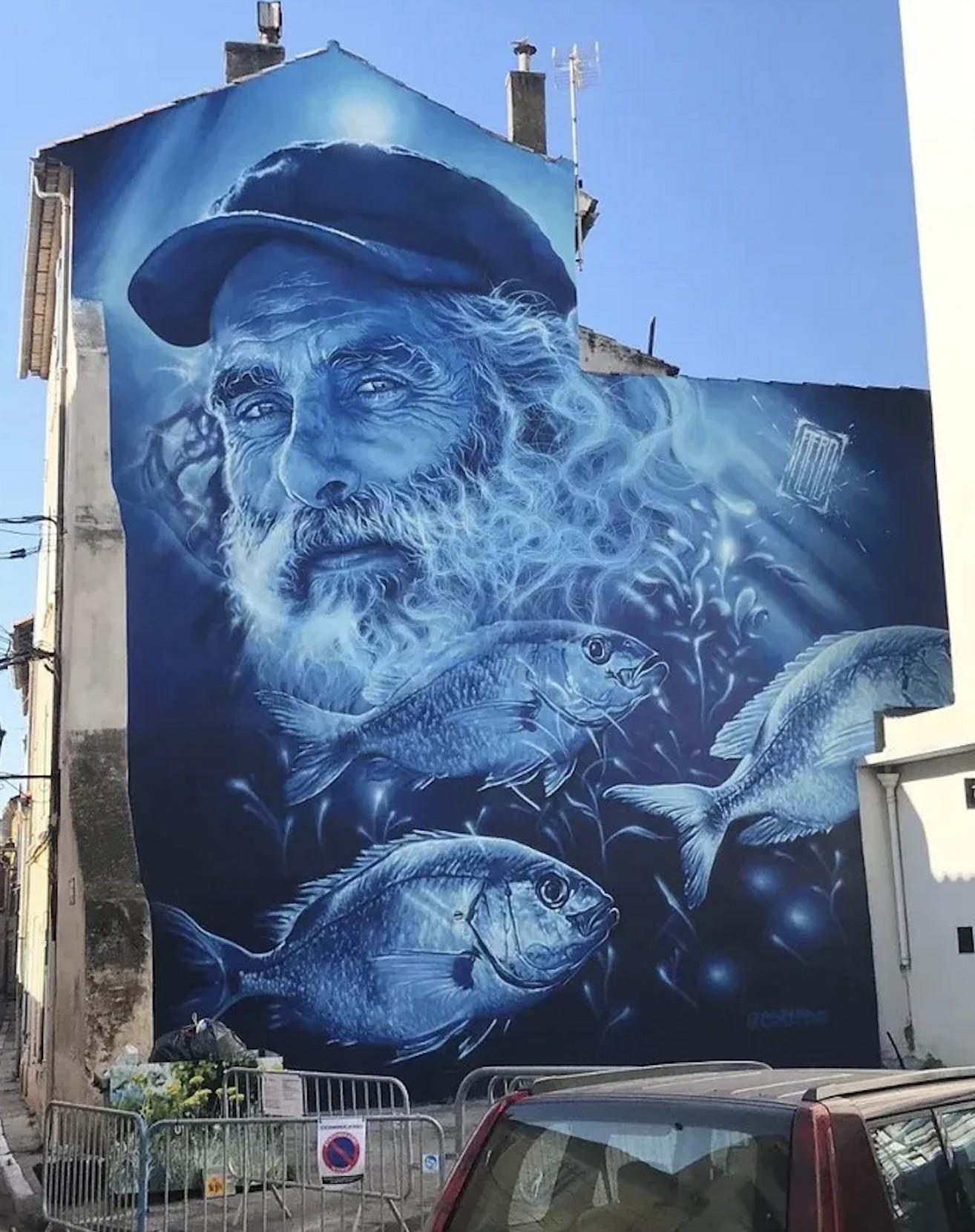 A mural by AÉRO in La Seyne-sur-Mer, France, showing a fisherman in a strong monochrome portrait.