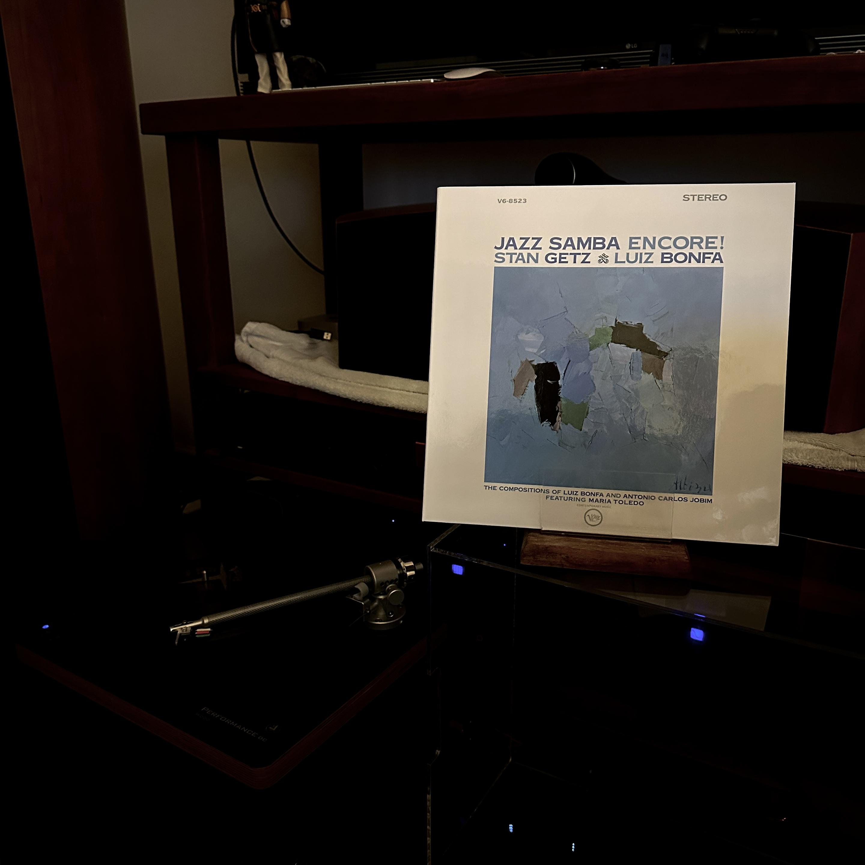 Photo of my Now Playing prop showing the album cover of Jazz Samba Encore! It's a white cover with blue title text. Inset is a blue themed abstract painting that is thematic with the other album covers in this Getz/Jobim Samba series.