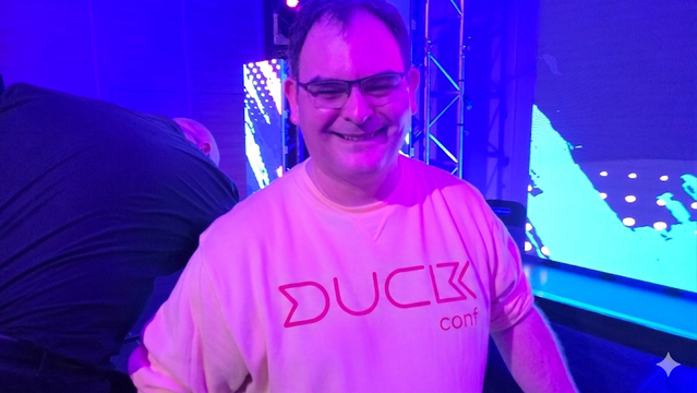 Dale wearing a devconf sweater reimagined as a duck conf sweater. 