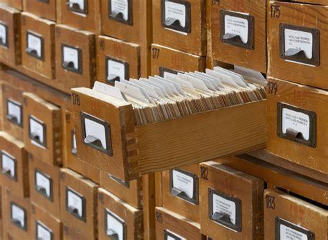 Card catalog with one drawer open showing the cards within.