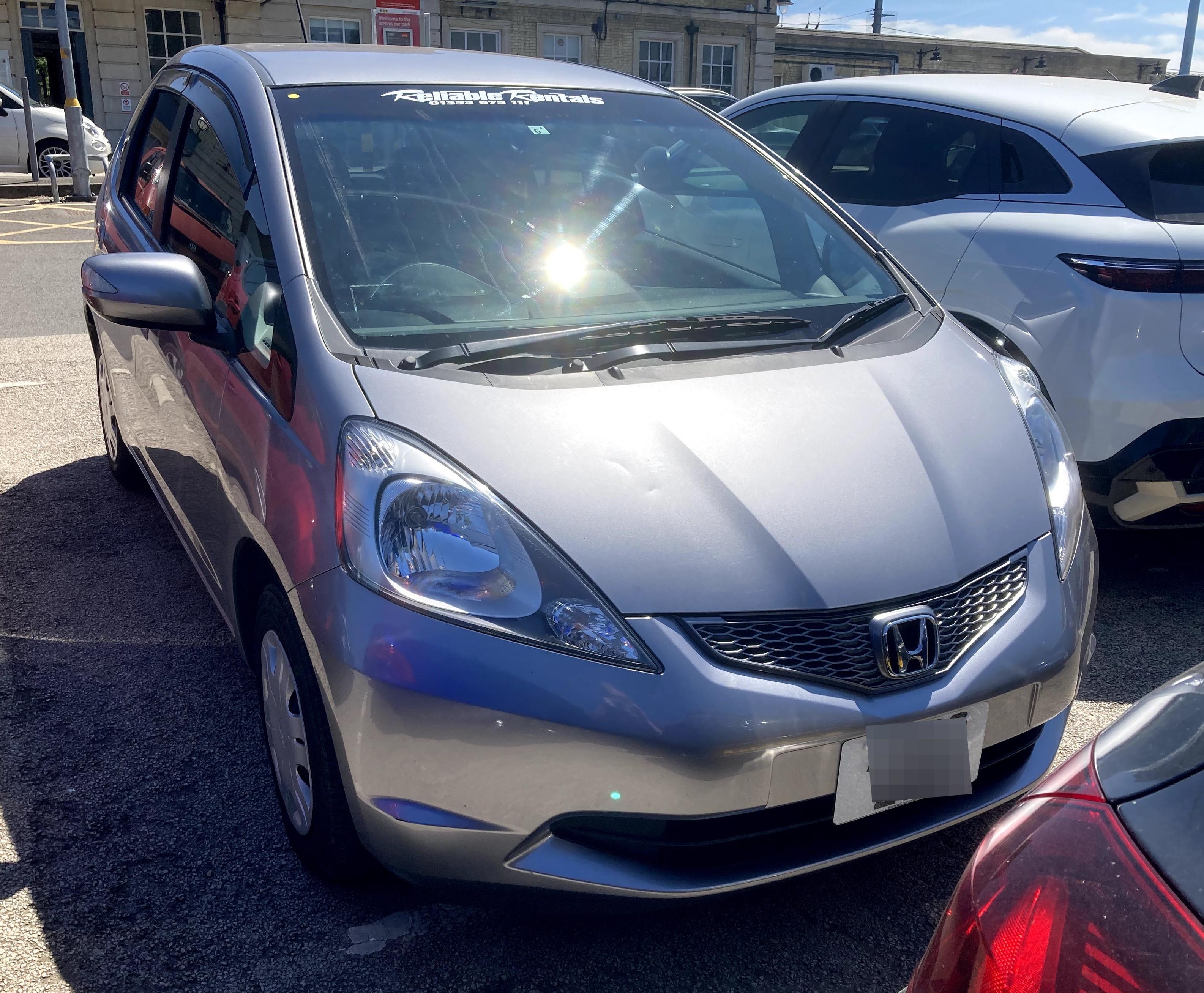 Silver second-generation Honda fit, front quarter view.