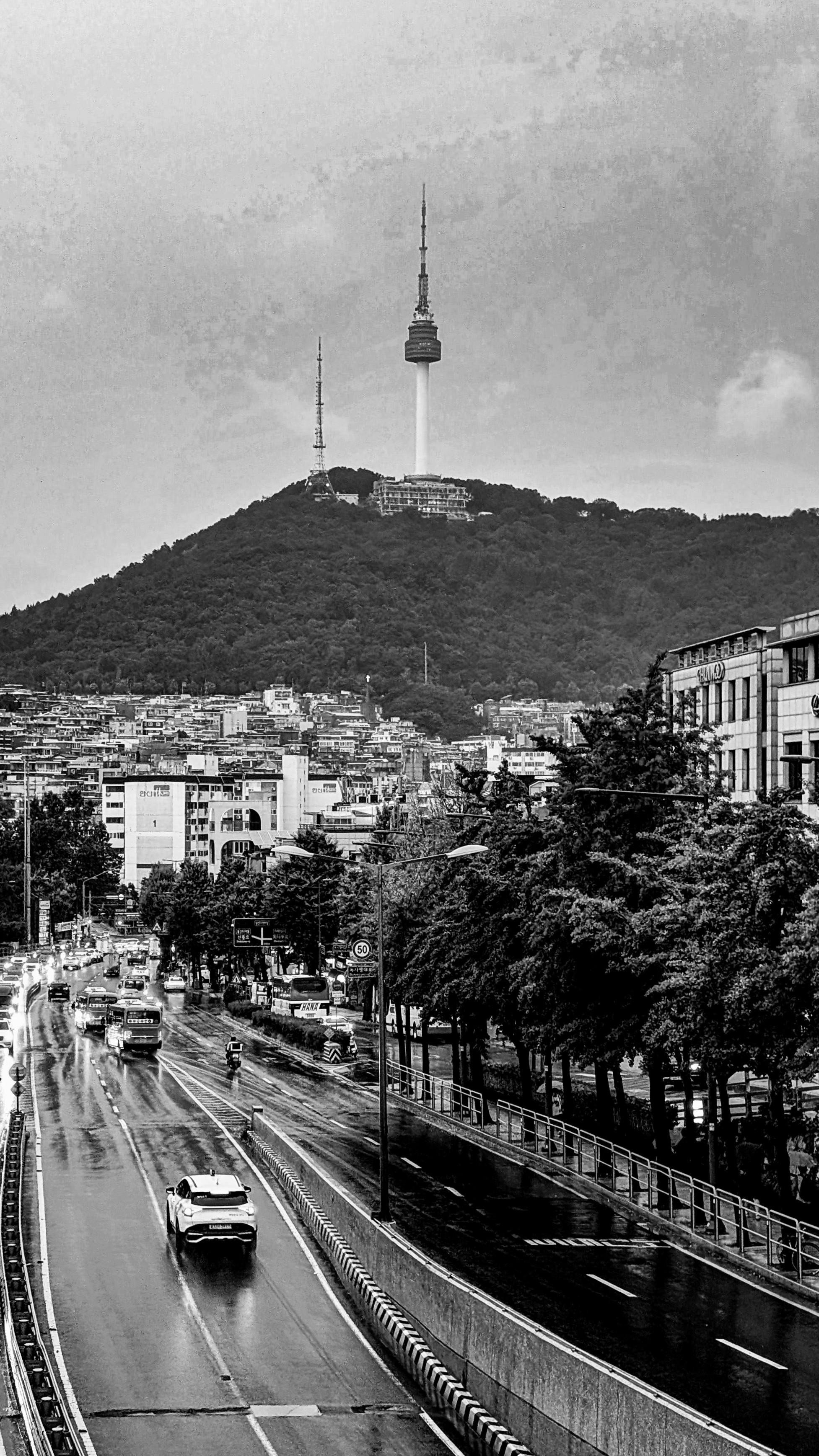 Black and white photo of Itaewon area in Seoul, where we stayed on our revisit. Taken during the evening, the thunderstorm had arrived. Image shows a busy road with the N Seoul Tower on the high.
The thunderstorm and heavy rain went on for over 14 hours non-stop. Some areas were flooded next morning.