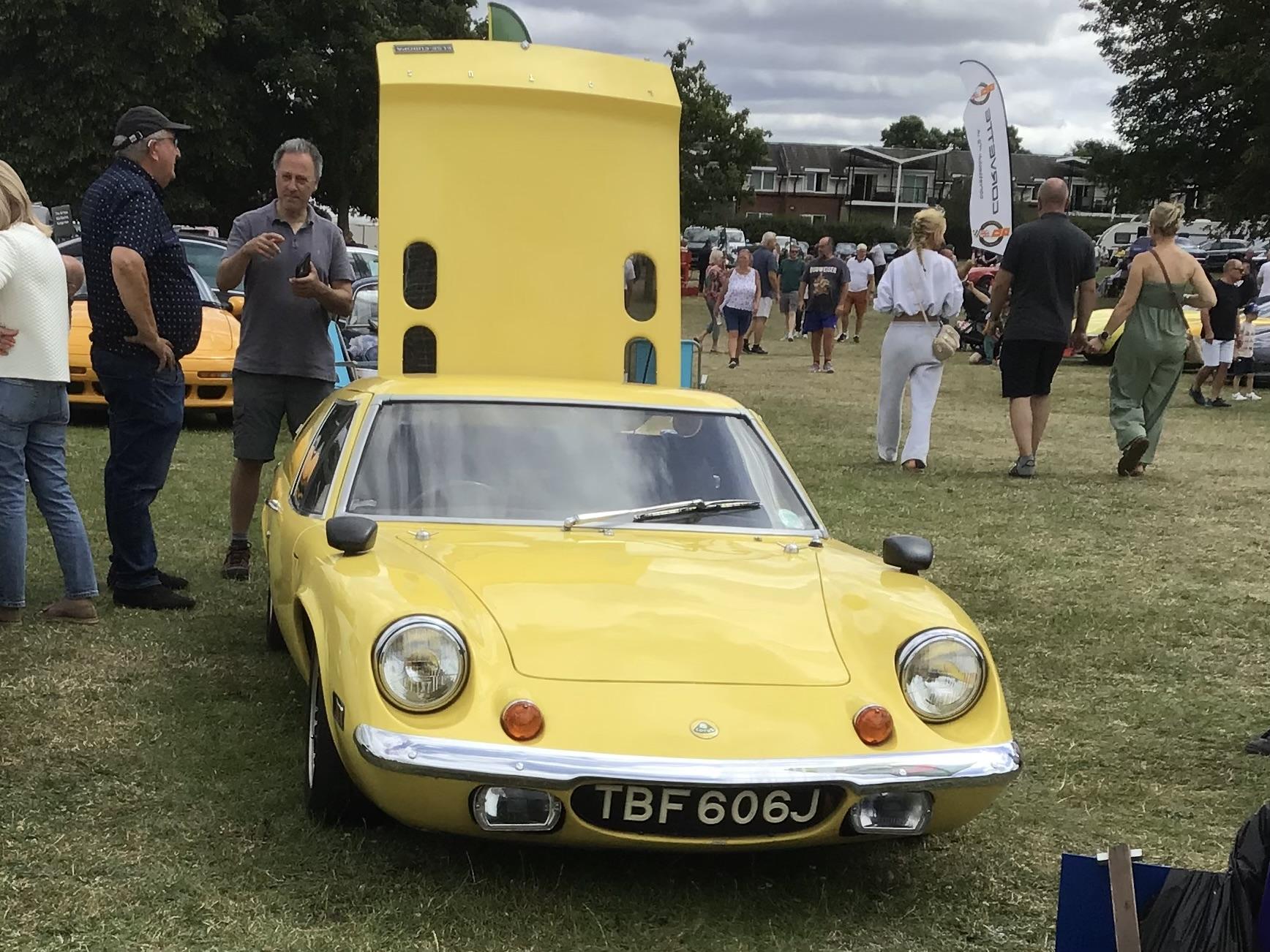 Yellow Lotus Europa with raised rear engine cover, frontal view