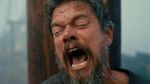 still frame of Matt Damen as Odysseus in the movie The Odyssey looking very distressed with an open mouth shouting expression