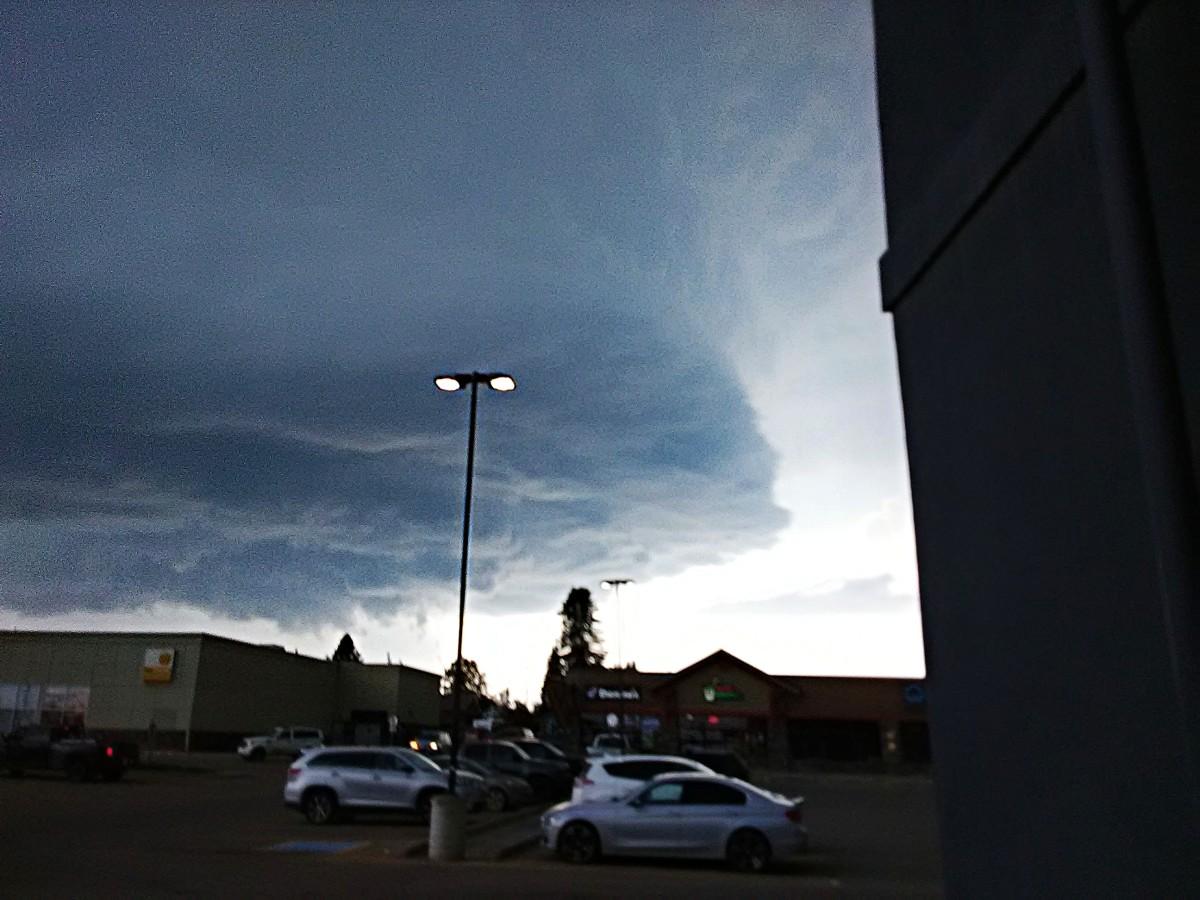 Same place as first shot. Another angle, we can see a bit of one side of the cloud and bit of the shelf, still not much of a view, but it does look very intense and active if you know thunderstorms. More of the parking lot visible.