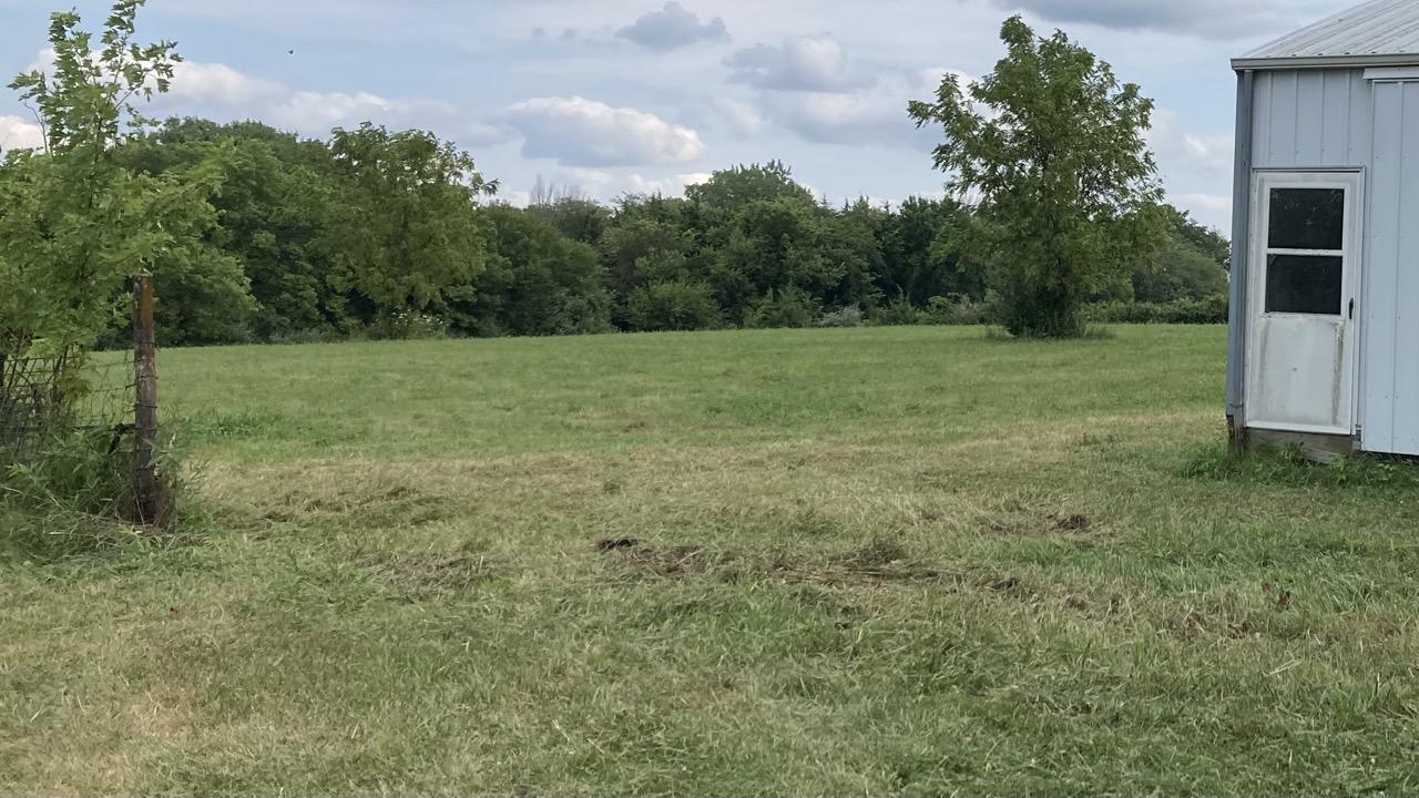 Yesterday.  The area to the left of the white building is now completely open. The roughed up freshly mowed area in the center is where the pen used to be.