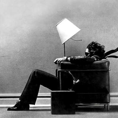 "Vintage" photo from a Maxell ad of someone sitting in a stiff breeze in a room - I forget if the original showed the audio source