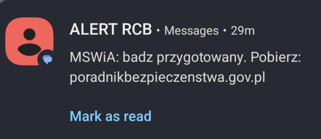 SMS z alertem RCB zawierający adres http do poradnika bezpieczeństwa.