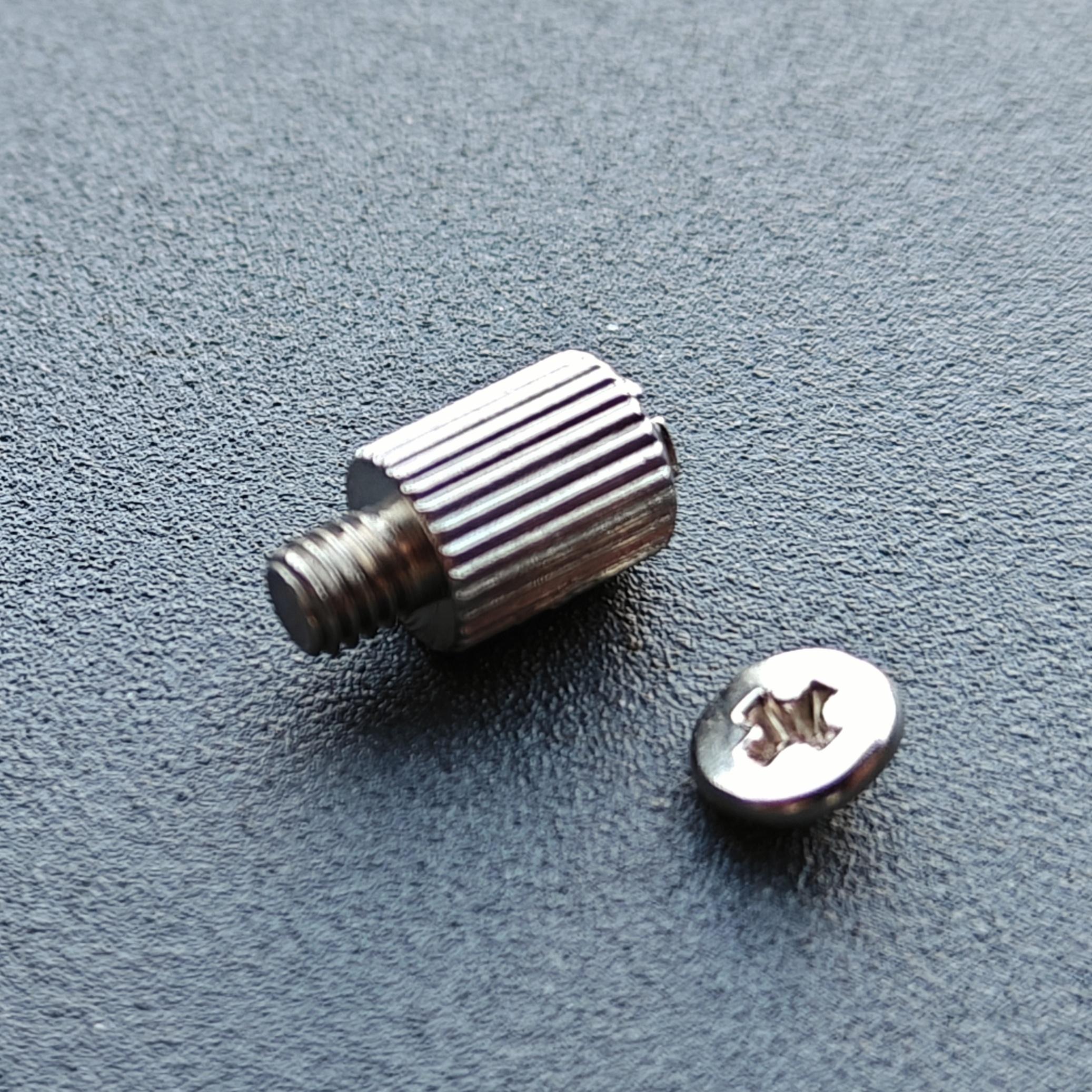 Motherboard M.2 stand-off with a broken-off screw head next to it.