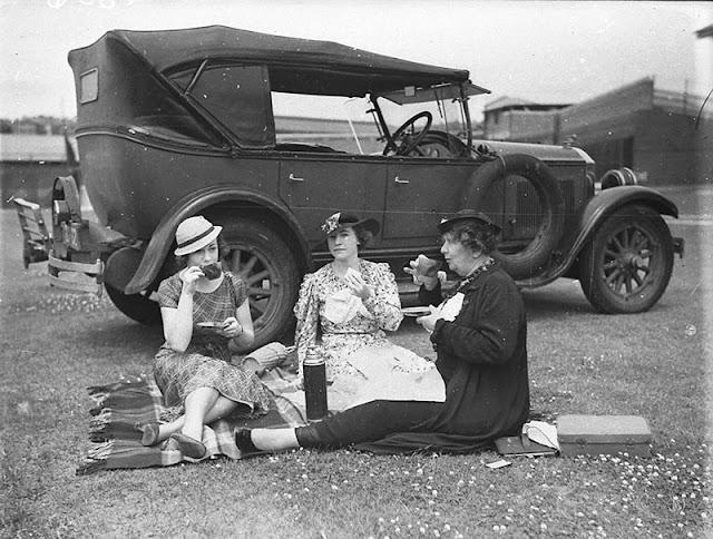Men and women appear in period  clothing, often seated around homemade food, baskets, and thermoses, enjoying moments of leisure away from daily struggles. These photos preserve the warmth, community spirit, and quiet joy of outdoor gatherings in the Great Depression era.