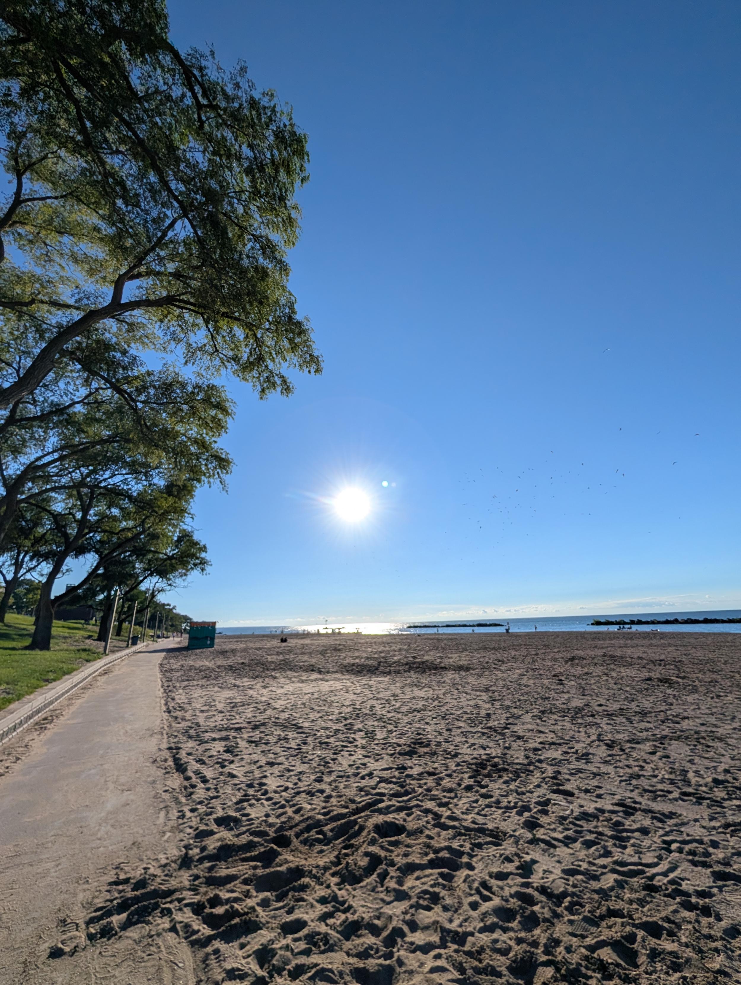 Sun over sand and water