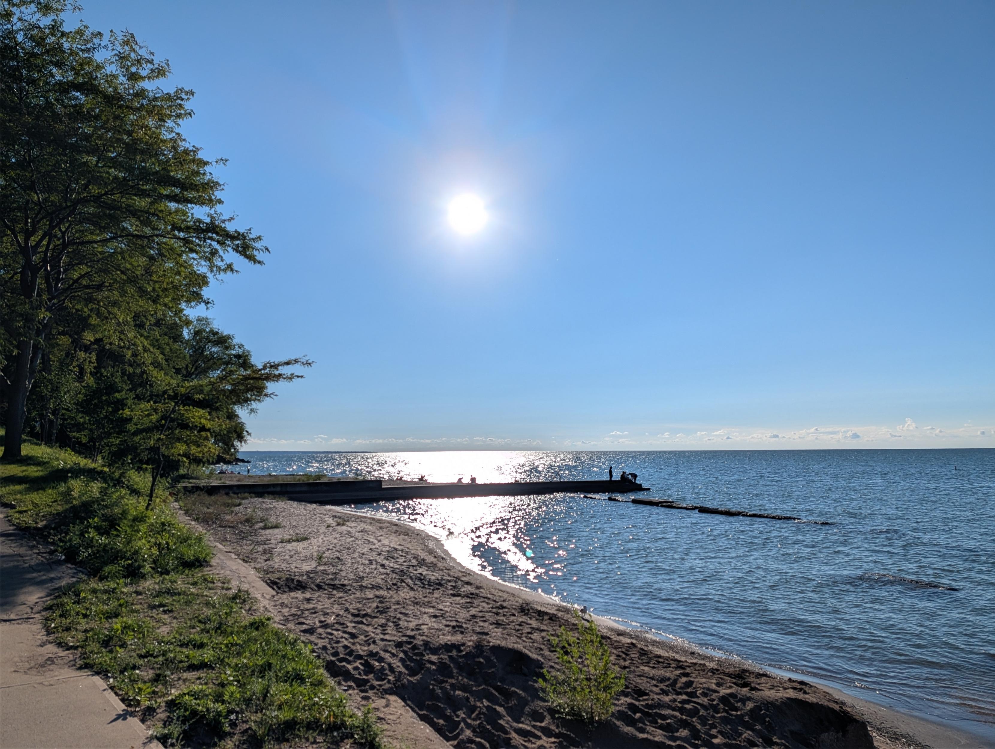Sun with a pier and choppy water